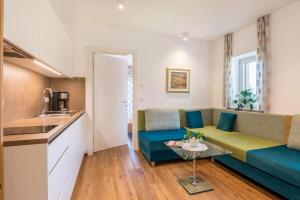 a living room with a couch and a table at Haus Rosengarten Apt B in Terlano