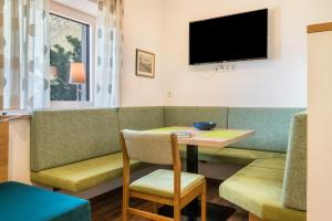 a living room with a table and a couch at Haus Rosengarten Apt B in Terlano