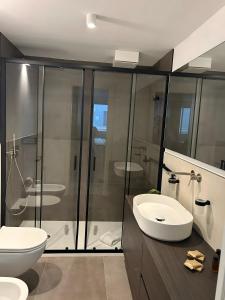 a bathroom with a shower and a toilet and a sink at Luxury Room in Bari