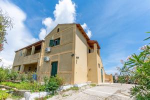 a building with a blue sky in the background at Blue apartment Corfu in Perivólion