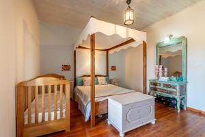 a bedroom with a canopy bed and a dresser at Blue apartment Corfu in Perivólion