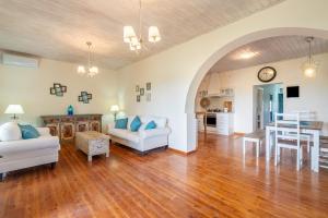 a living room with a wooden floor and a dining room at Blue apartment Corfu in Perivólion