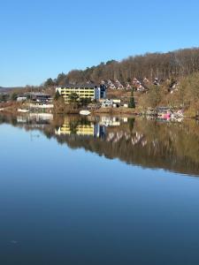 a view of a lake with buildings in the background at Sternschnuppe in Kirchheim +8 photos