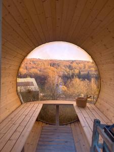 a large round window in a wooden room with a table at Sternschnuppe in Kirchheim