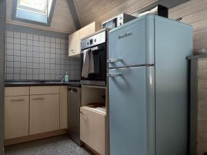 a kitchen with a stainless steel refrigerator and a stove at Sternschnuppe in Kirchheim