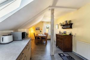 a kitchen with a counter with a microwave and a table at Ferienwohnung Schlossbergblick in Arnsberg