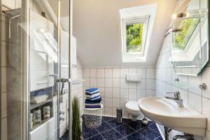 a bathroom with a sink and a toilet at Ferienwohnung Schlossbergblick in Arnsberg +16 photos