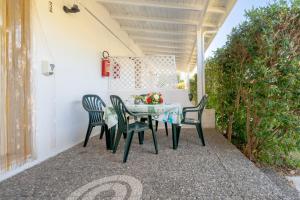 a table and four chairs on a patio at Agriturismo Alimini a Otranto in Alimini