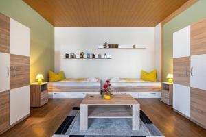 a room with two beds and a table at Ferienhaus Nestwärme in Calau