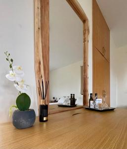 a room with a vase with flowers on a wooden floor at Daniel's Hotel Apartments in Paphos