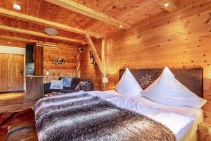 a bedroom with a bed in a wooden room at Chalet Alpenherz in Inzell