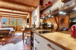 a kitchen with a counter with a stove top oven at Chalet Alpenherz in Inzell