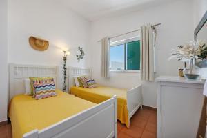 a bedroom with two beds and a window at V-Blue in Alvor +31 photos
