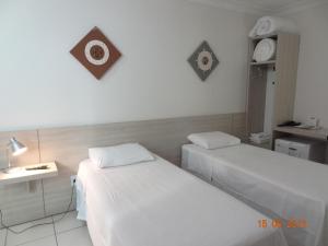 a hospital room with two beds and a desk at Hotel FIT in Palmas