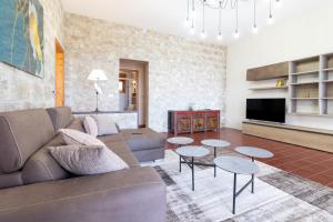 a living room with a couch and tables at Villa Serra in Marina Serra