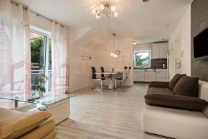 a living room with a couch and a table at Familien-Apartment 2 in Meersburg