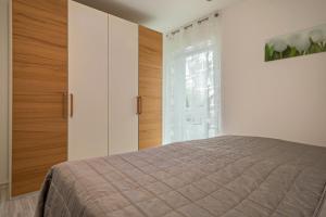 a bedroom with a bed and a large window at Familien-Apartment 2 in Meersburg