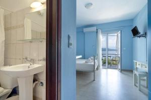 a bathroom with a sink and a toilet and a tub at Giorgio studios-apartments 1 in Nikiana +55 photos