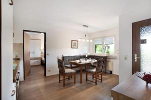a dining room and living room with a table and chairs at Ruhrtalblick in Bestwig
