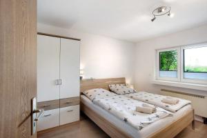 a bedroom with a large bed and a window at Ruhrtalblick in Bestwig