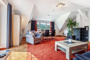 a living room with a table and chairs at Haus Schönblick - "Fewo Sarina 2" in Willingen