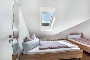 a bedroom with two beds and a window at Haus Schönblick - "Fewo Sarina 2" in Willingen +22 photos