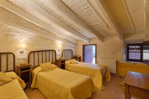 a hotel room with two beds and a window at Ca l'Emilli in Gélida +29 photos