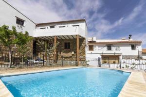 a swimming pool in front of a house at Casa Rural Albaida in Laroya