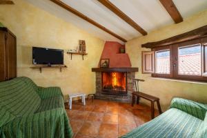 a living room with a fireplace and a tv at Casa Rural Albaida in Laroya