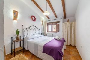 a bedroom with a large bed in a room at Casa Rural Albaida in Laroya +21 photos