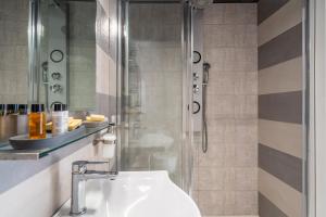 a bathroom with a sink and a shower at Ortigiadreamrooms 12 in Syracuse +23 photos