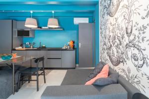 a kitchen and a living room with a couch and a table at Ortigiadreamrooms 12 in Syracuse