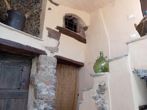 a green bottle hanging on the side of a building at Agriturismo U' Spigu Nonna Annetta in Nasino +37 photos