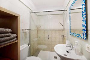 a bathroom with a shower and a toilet and a sink at Casa Lía in La Santa +14 photos