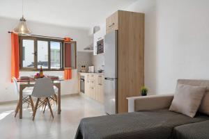 a kitchen and living room with a couch and a table at Casa Lía in La Santa