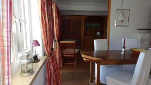 a dining room with a table and a window at Haus Elbrächter Ferienwohnung 2 in Gstadt am Chiemsee