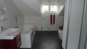 a white bathroom with a sink and a toilet at Haus Elbrächter Ferienwohnung 2 in Gstadt am Chiemsee