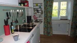 a kitchen with a sink and a counter with utensils at Haus Elbrächter - Erdgeschoss in Gstadt am Chiemsee