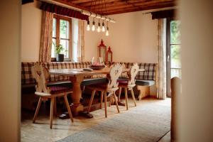 a dining room with a wooden table and chairs at Chalet Hinterweiding Gut in Wiederriesen +37 photos