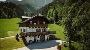a large house in the middle of a green field at Chalet Hinterweiding Gut in Wiederriesen