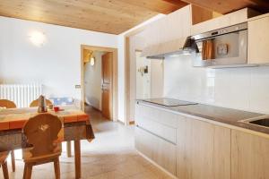 a kitchen with a table and a counter top at Appartamenti Elisabetta n1 in Livigno +15 photos
