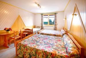 a bedroom with two beds and a desk and a table at Domaine de la Chambre in Verrières