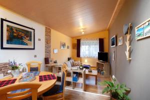 a living room with a table and a dining room at Ferienwohnung Failte in Niederselters +14 photos