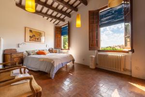 a bedroom with a bed and a large window at Masia Sant Miquel in Canet de Mar