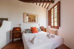 a bedroom with a white bed and a window at Masia Sant Miquel in Canet de Mar +28 photos