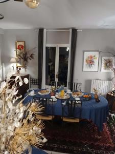 a blue table with plates of food on it at Chambres D'hôtes Au Gré Du Temps in Saint-Aignan +46 photos
