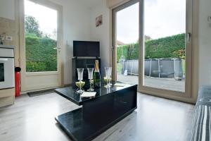 a living room with a table with wine glasses at Chalet avec piscine privée in Savignac-les-Églises