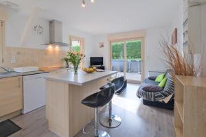 a kitchen with a island in the middle of a room at Chalet avec piscine privée in Savignac-les-Églises
