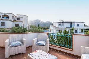 a balcony with chairs and a view of the water at Azzurra in Orosei