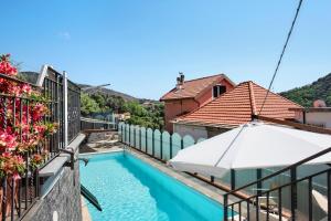 a view of a swimming pool from the balcony of a house at Casa Gocce Di Cristallo in Varazze